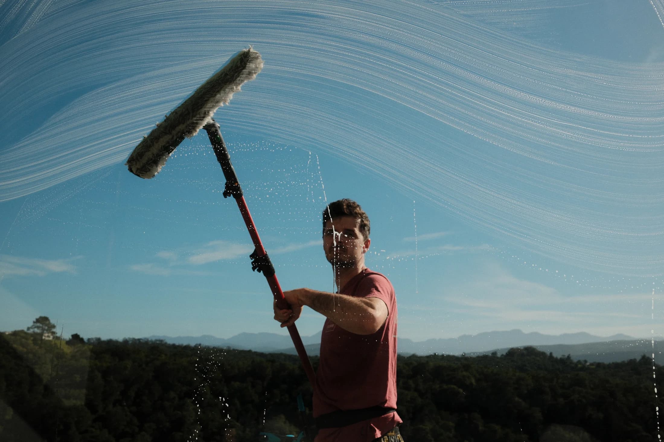 Ross, the owner of ProWash Knysna, cleaning glass by hand